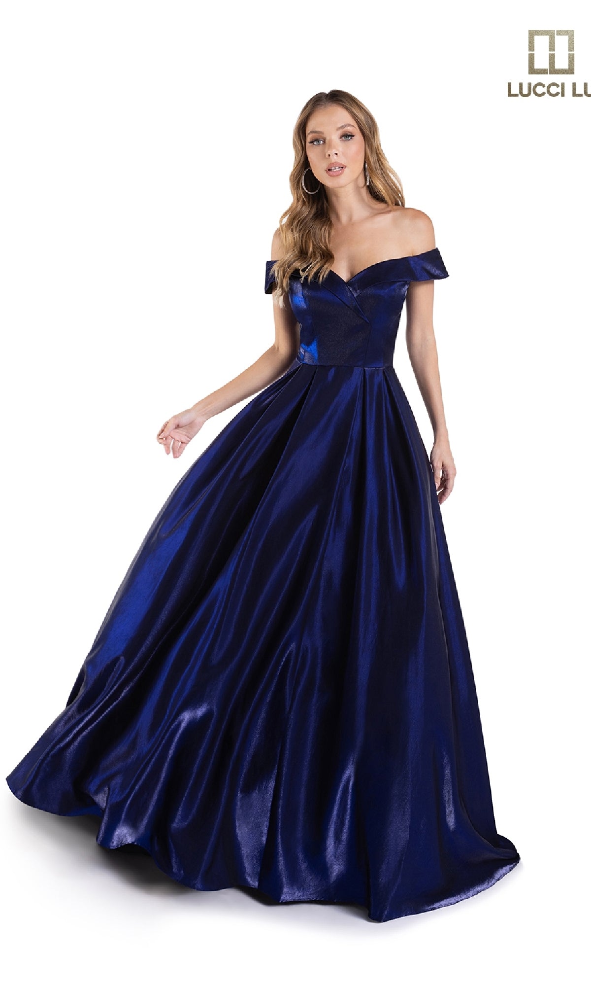 A woman models the Lucci Lu 28063, an off-the-shoulder satin prom dress with a full A-line skirt in dark blue, standing against a white background.